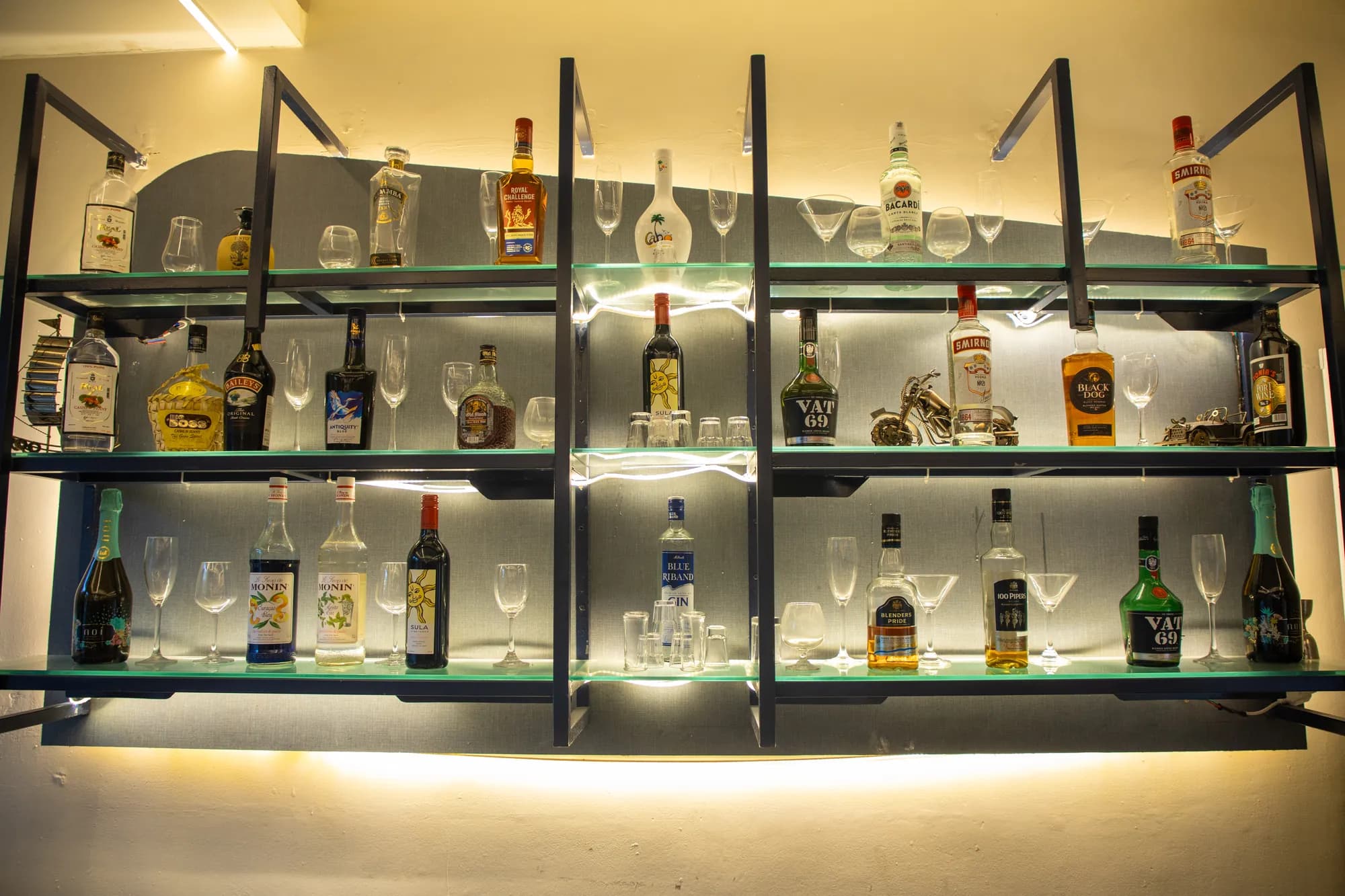 Backlit shelves stocked with spirits