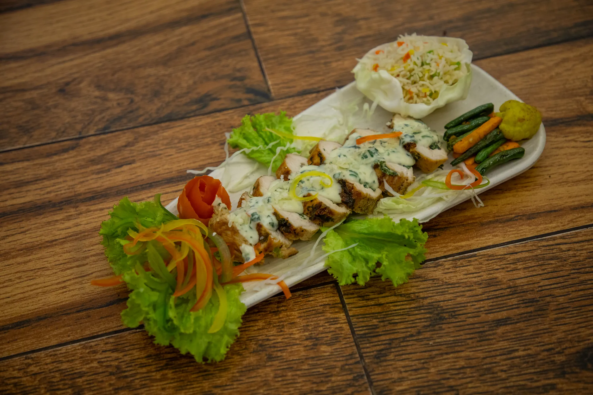Chicken rolls with a creamy sauce and salad