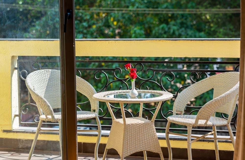 Wicker chairs and table on the Deluxe City View balcony