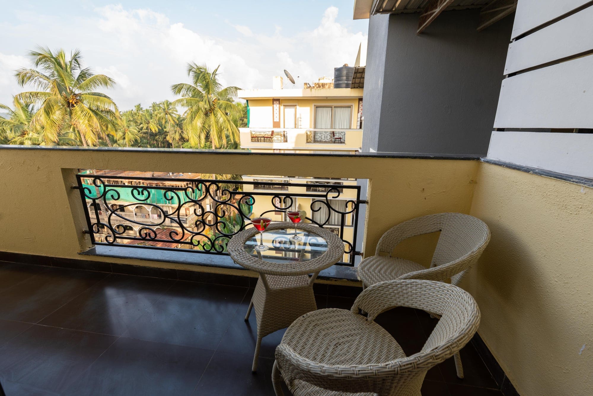 Family Room private balcony with wicker chairs and palm trees
