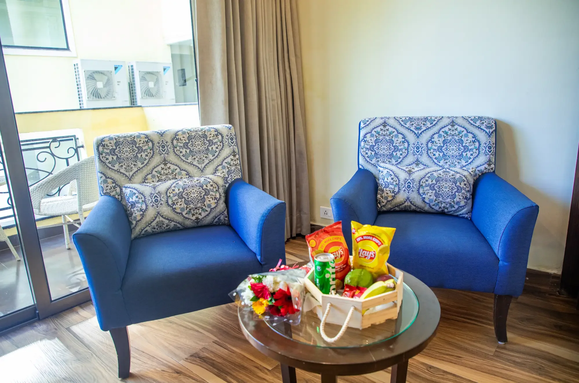 Junior Suite seating area with welcome hamper by the balcony