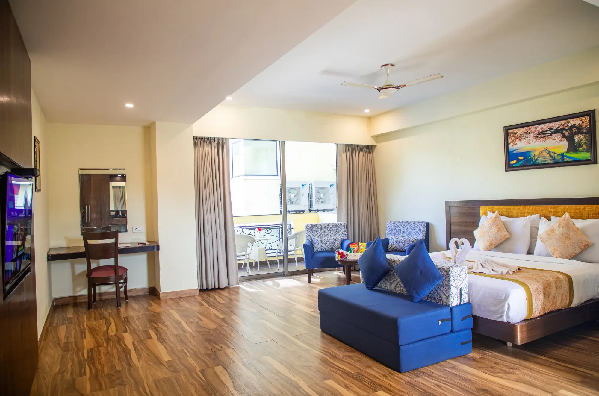 Junior Suite work desk and view towards the balcony