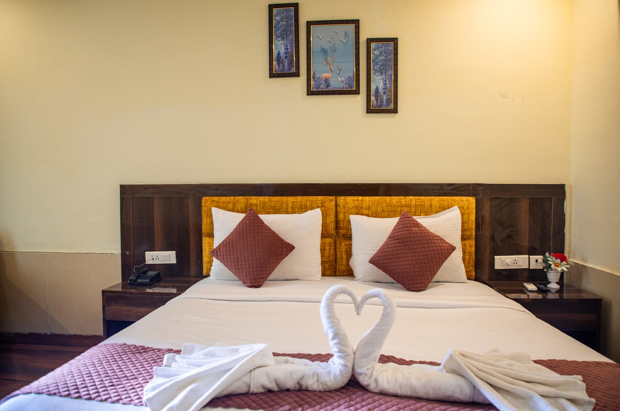 Standard Room bed with towel art and cushions