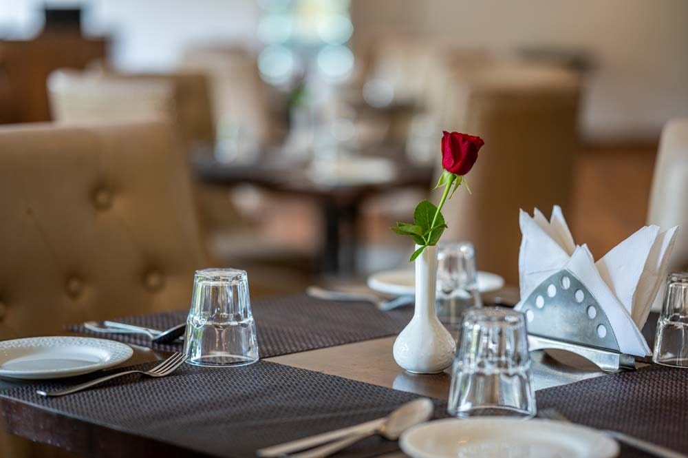 A rose on a set table at Bell Pepper