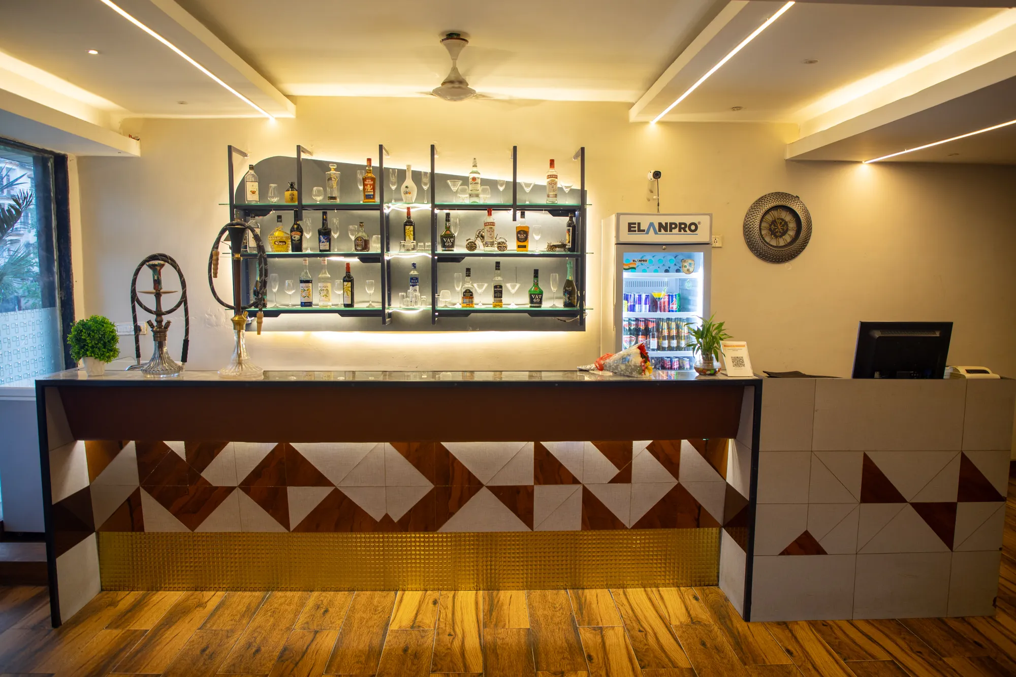 Bar counter with a geometric tiled front and wooden floor