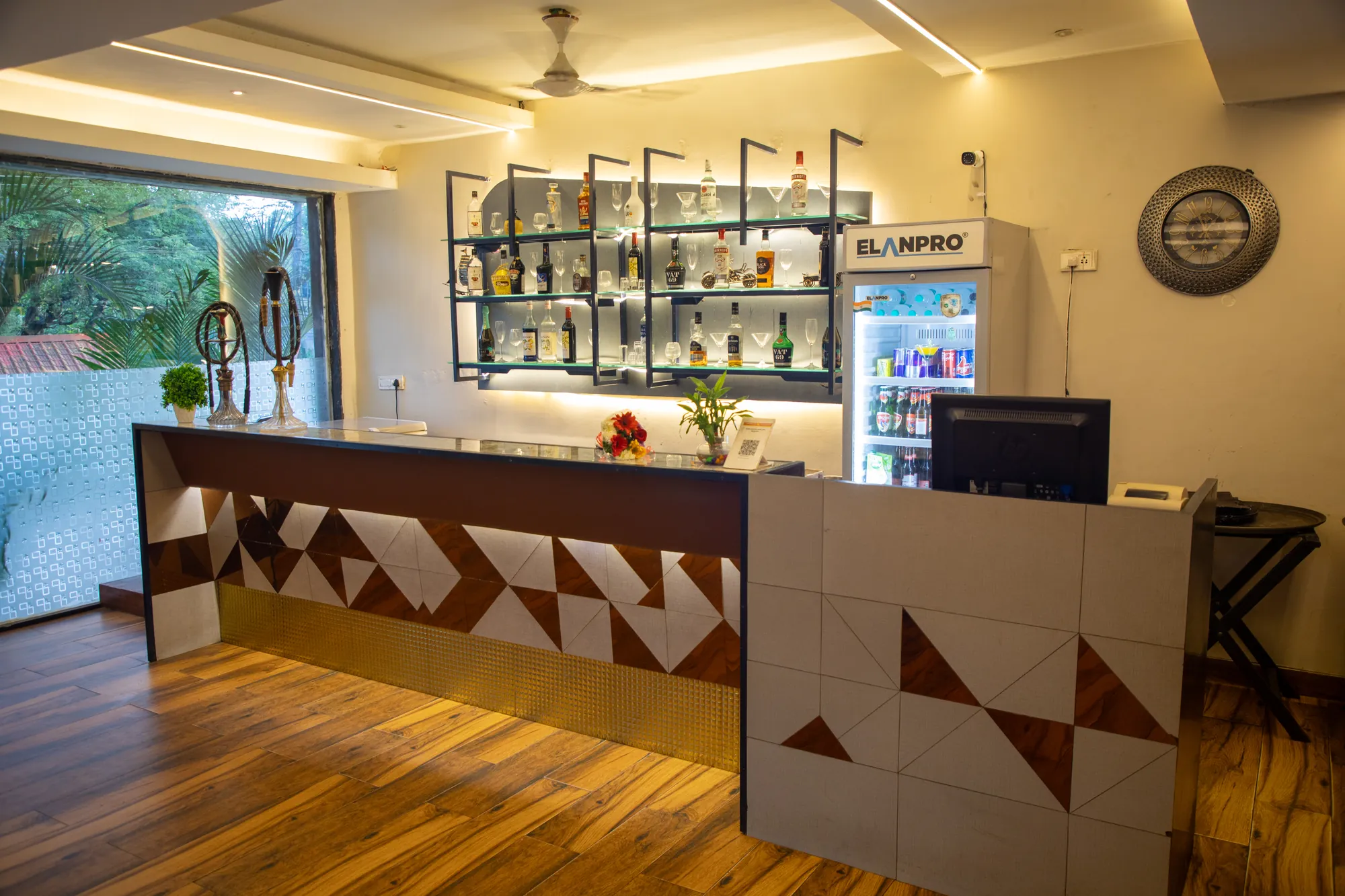 Pirates of Drinks Bar counter with backlit bottle shelves and a window onto the palms