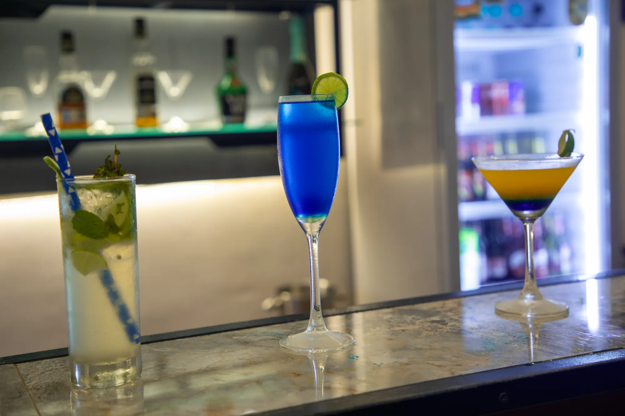 Cocktails on the counter beside the drinks fridge