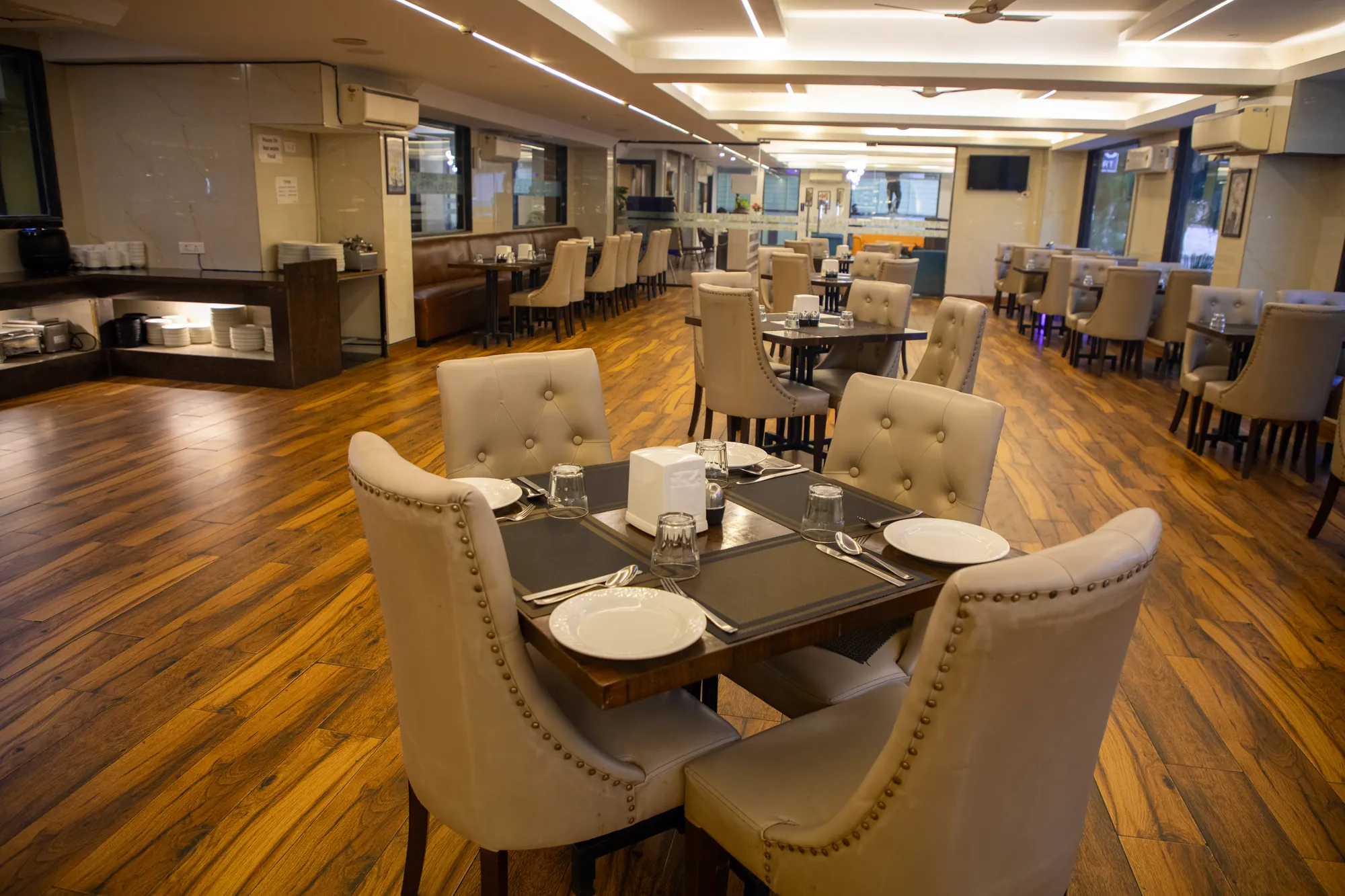Dining hall with tufted chairs and wooden floors