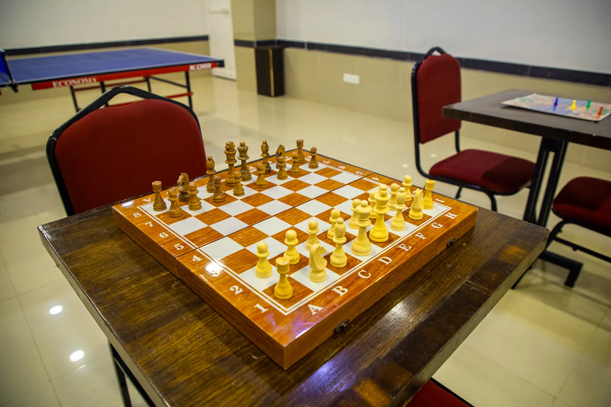 Wooden chess set on a games table