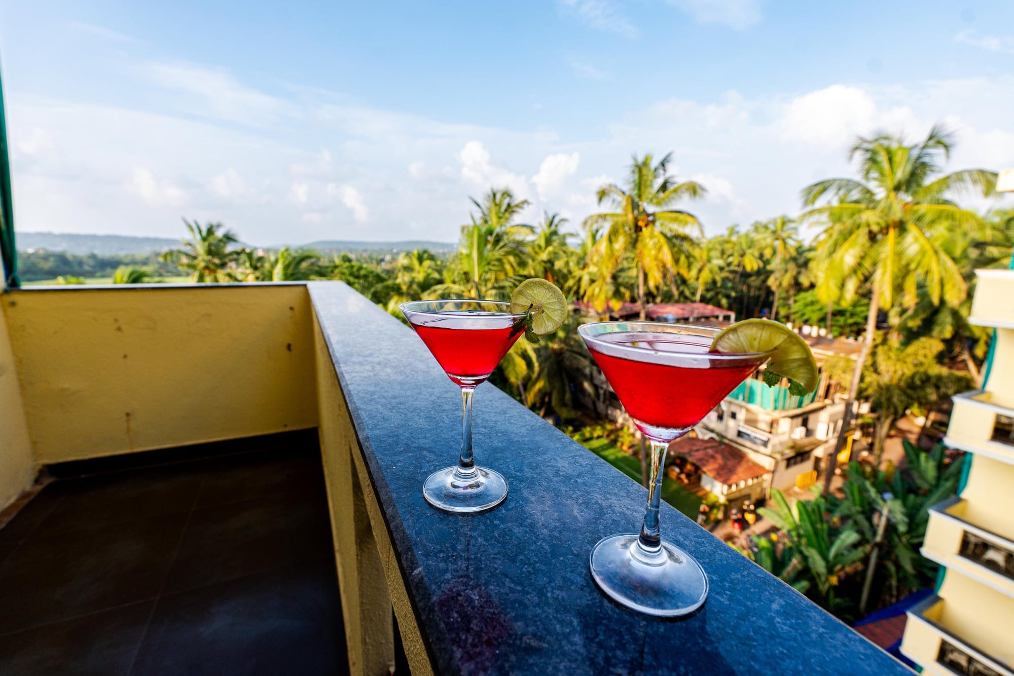 Cocktails on a balcony ledge above the palms