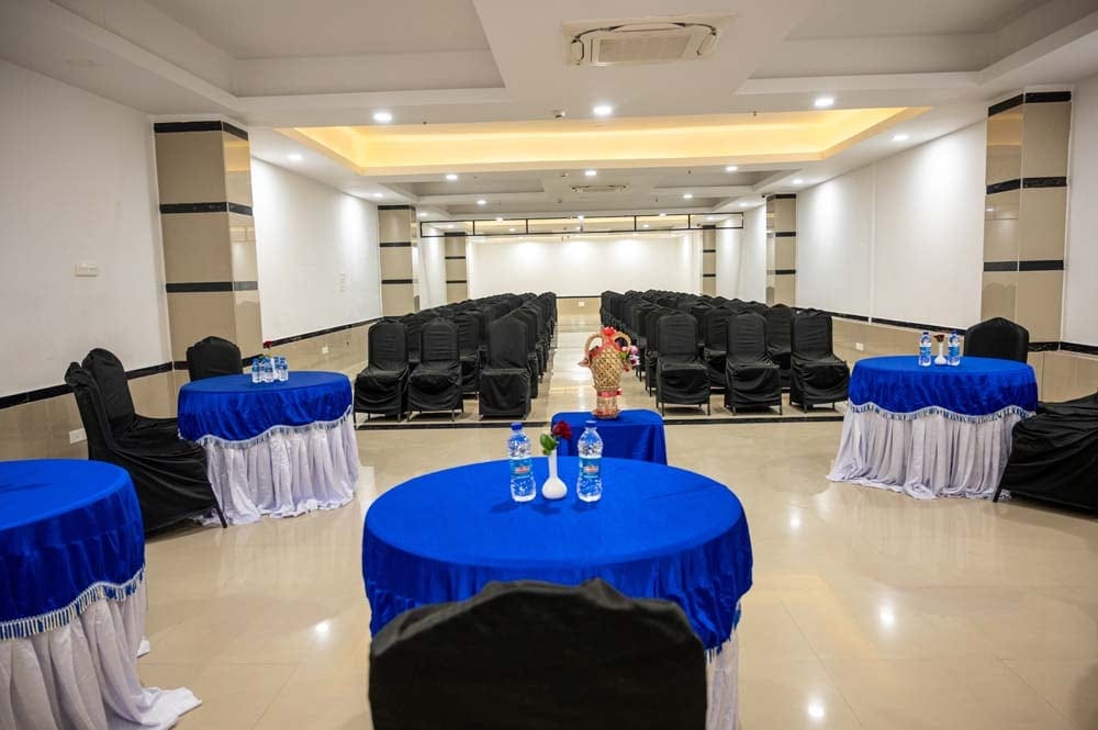 Conference hall set with round tables and theatre seating