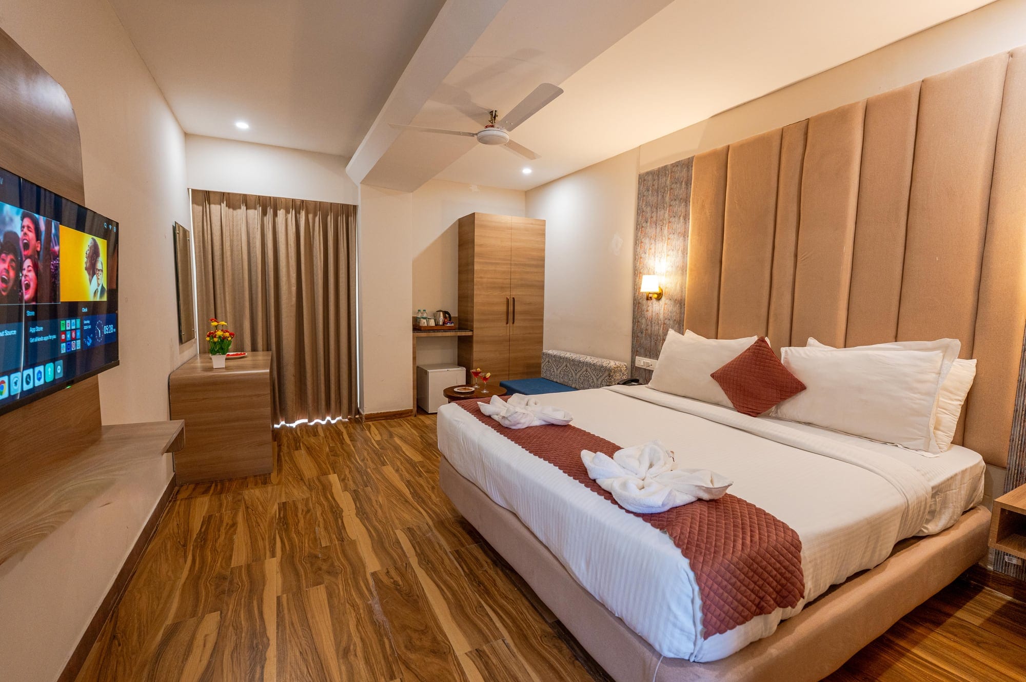 Family Room bedroom with king bed, upholstered headboard and TV